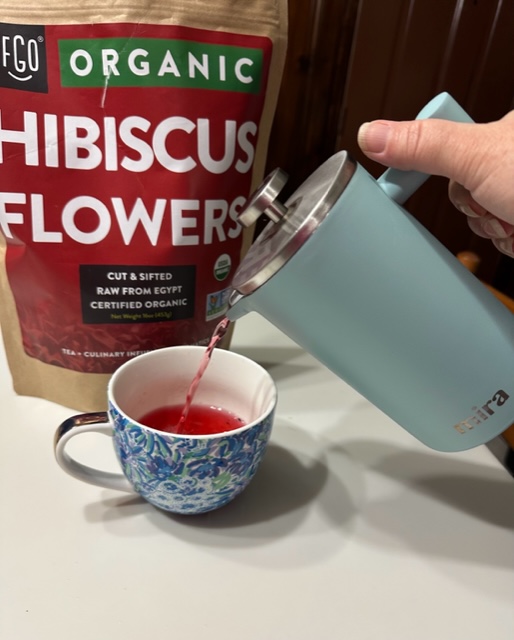 Using a MIRA coffee press to press hibiscus flowers to make hibiscus tea. 